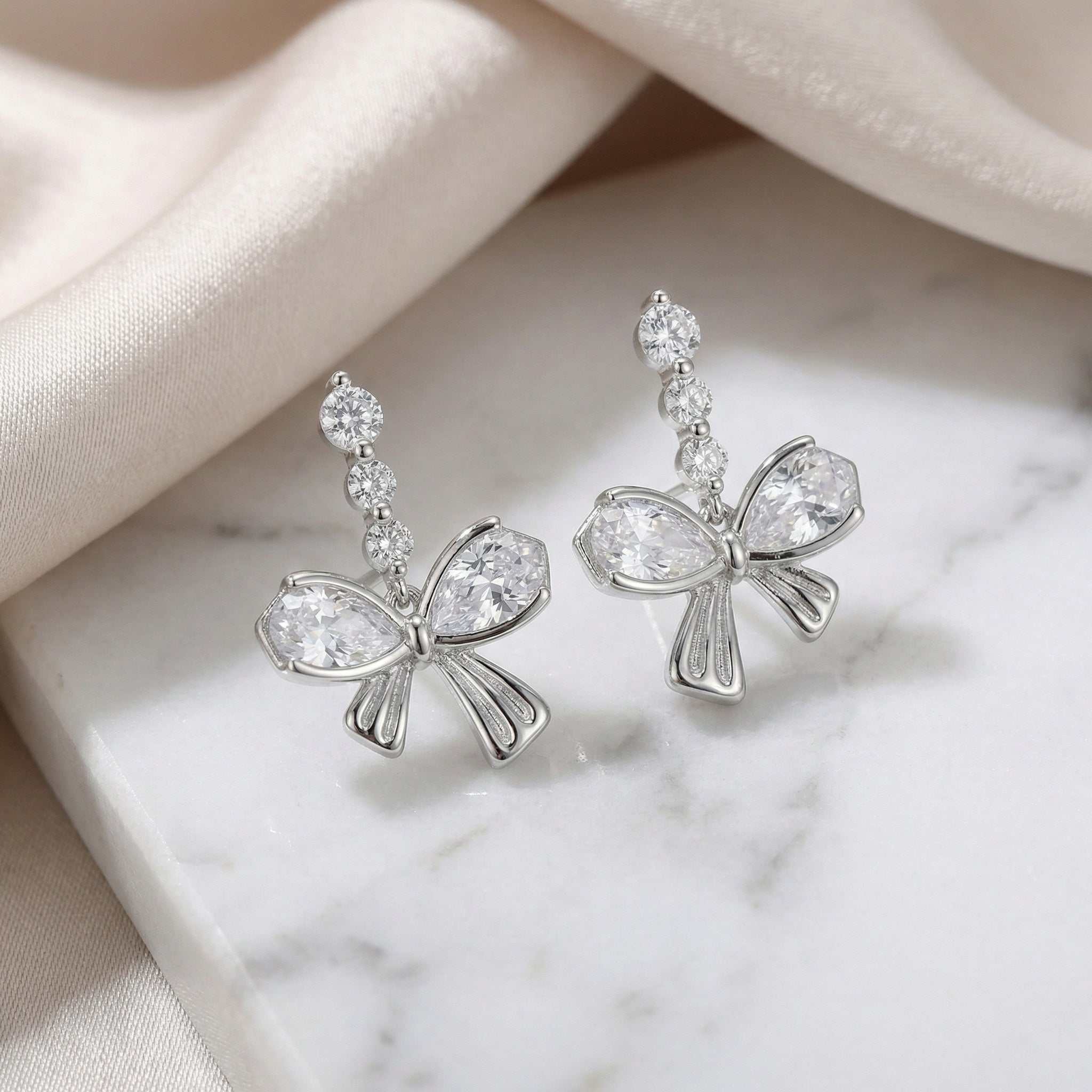 925 Sterling Silver Elegant Sparkling Silver Bow Drop Earrings with Pear-Cut Accents