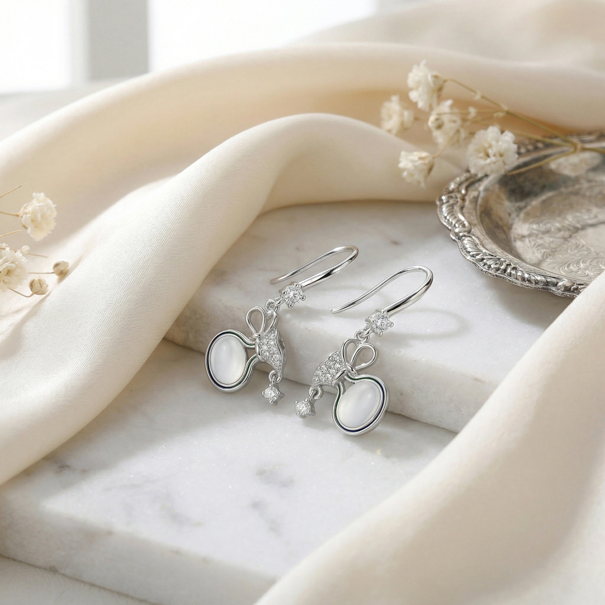 925 Sterling Silver Elegant Silver Bow Drop Earrings with Milky Moonstones and Sparkling Accents